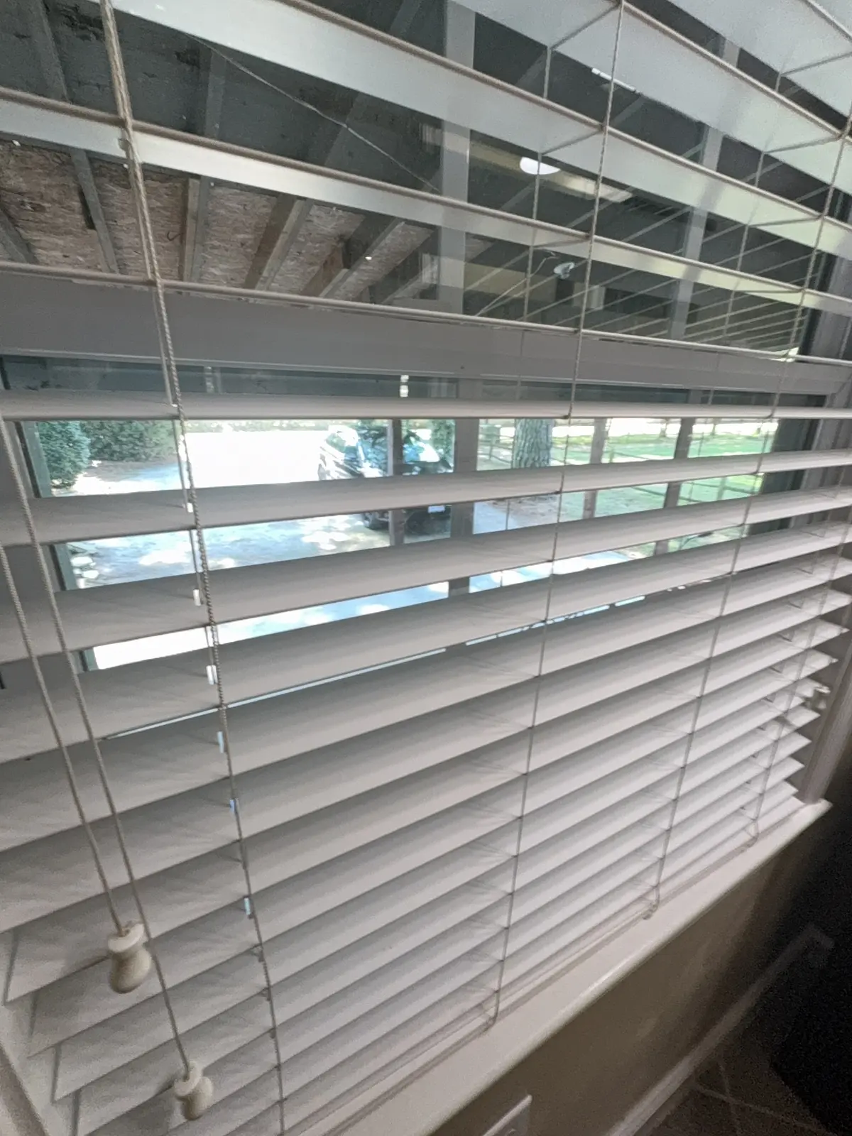 White window blinds cleaned by Habitat Cleaning Co. in a Hampton Roads client home